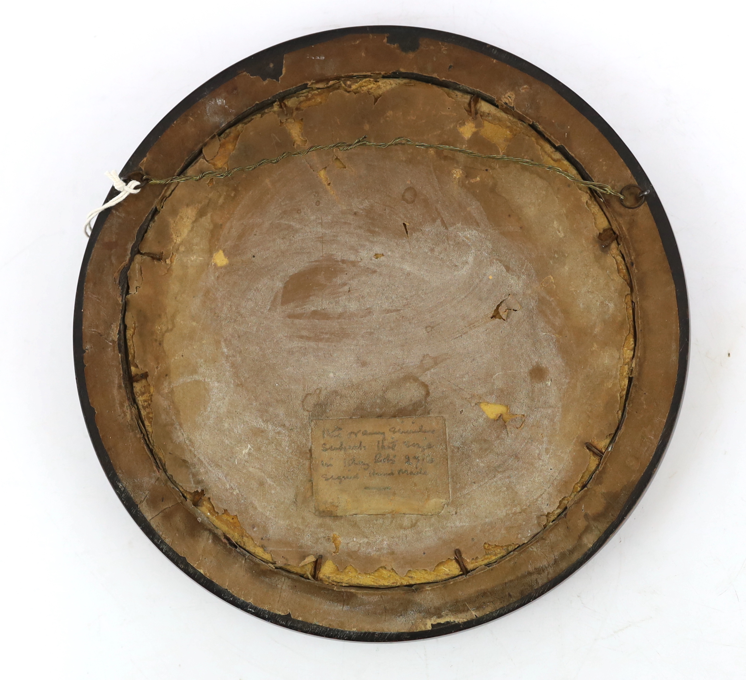 An Arts and Crafts brass and copper roundel, in the manner of Archibald Knox, monogrammed CA, ebony framed, overall 27cm